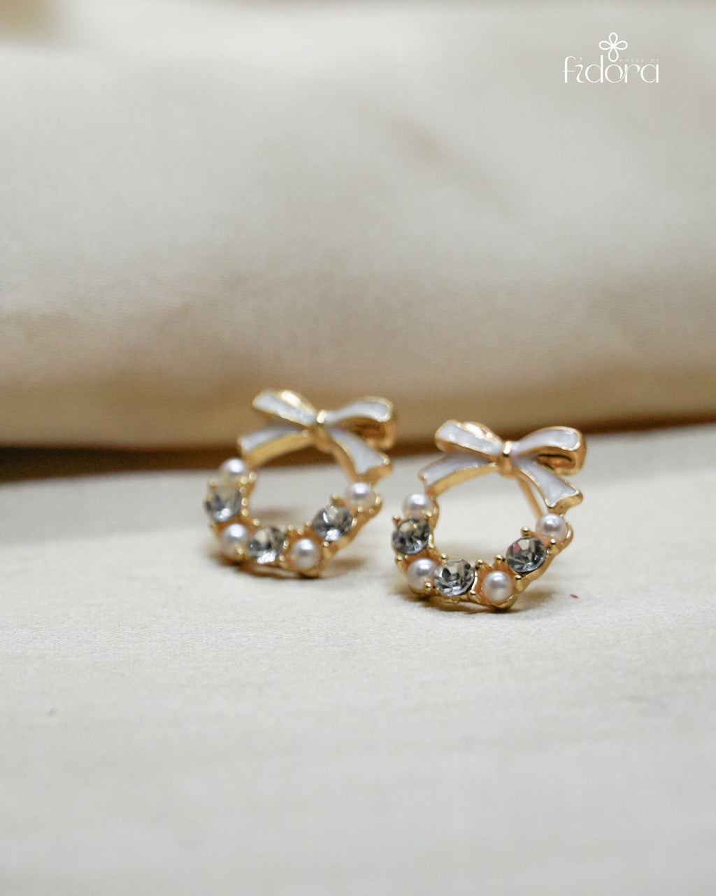 Anti-tarnish gold plated earring featuring a cute bow knot design with embedded stones, perfect for daily wear and elegant fashion styling.