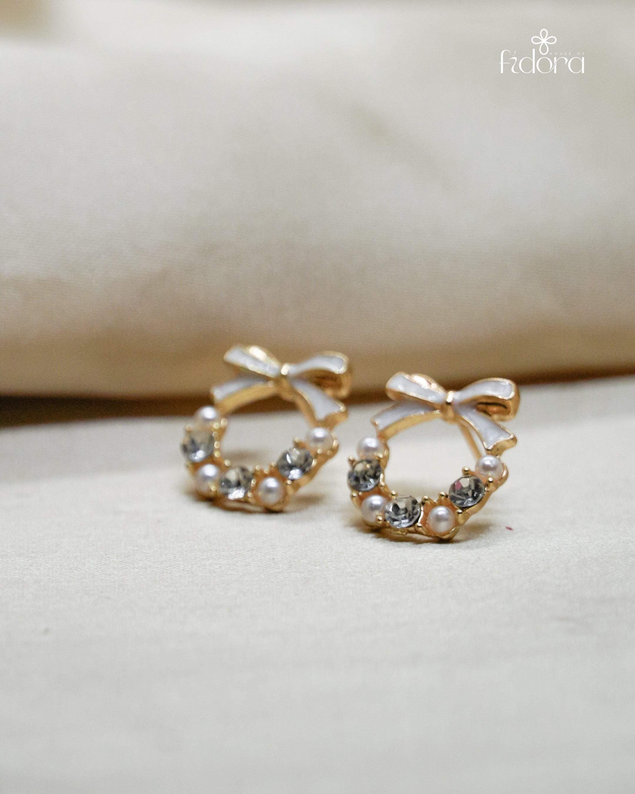 Anti-tarnish gold plated earring featuring a cute bow knot design with embedded stones, perfect for daily wear and elegant fashion styling.